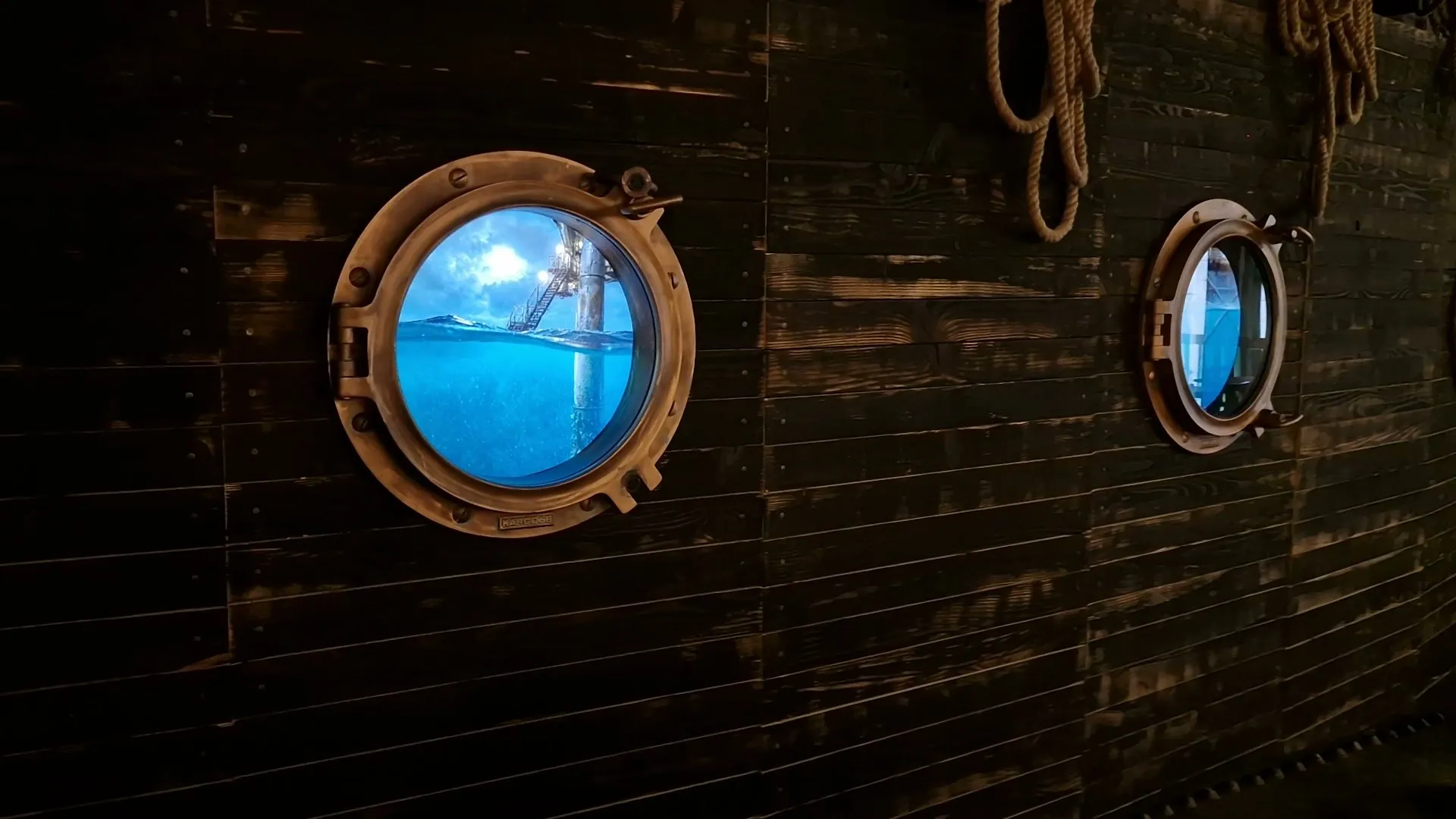 Two portholes on the wooden wall